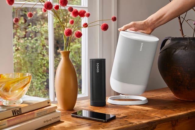 Display Me e-commerce team member wearing headphones in neon-lit workspace